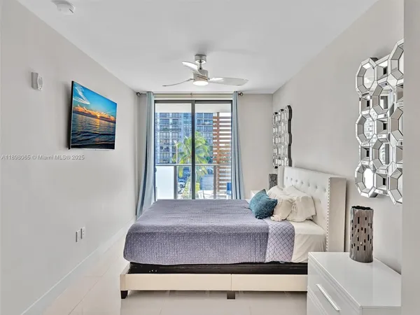 a bedroom with a large bed and a window