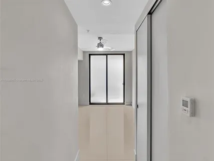 an empty room with a empty space and a ceiling fan