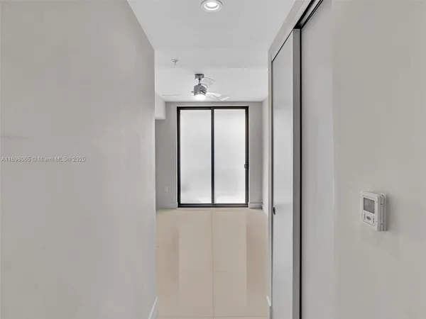 an empty room with a empty space and a ceiling fan