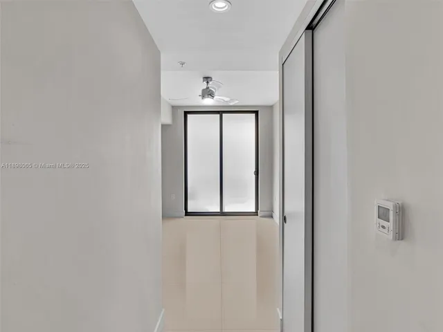 an empty room with a empty space and a ceiling fan