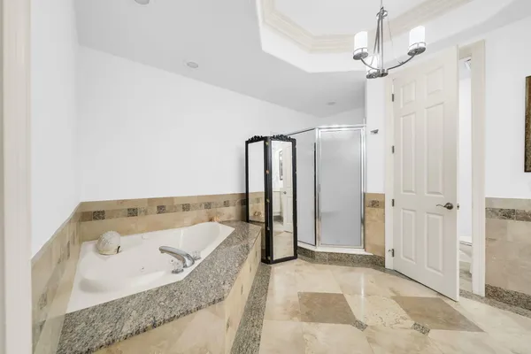 a bathroom with a sink and a mirror with shower