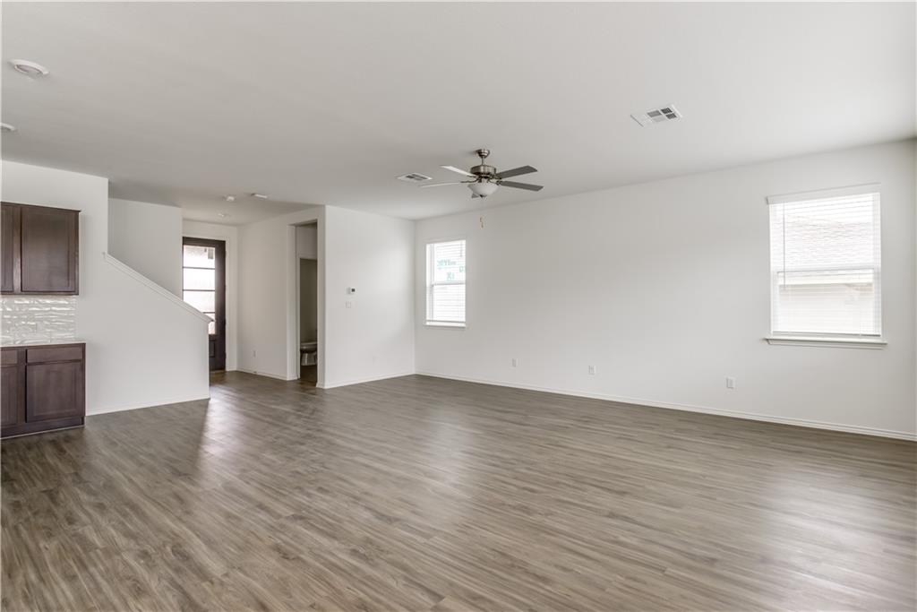 712 Affazia Lane Georgetown, TX 78628 - Photo 2 of 40 an empty room with wooden floor and windows