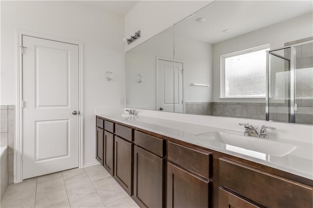 712 Affazia Lane Georgetown, TX 78628 - Photo 23 of 40 a bathroom with a double vanity sink and mirror