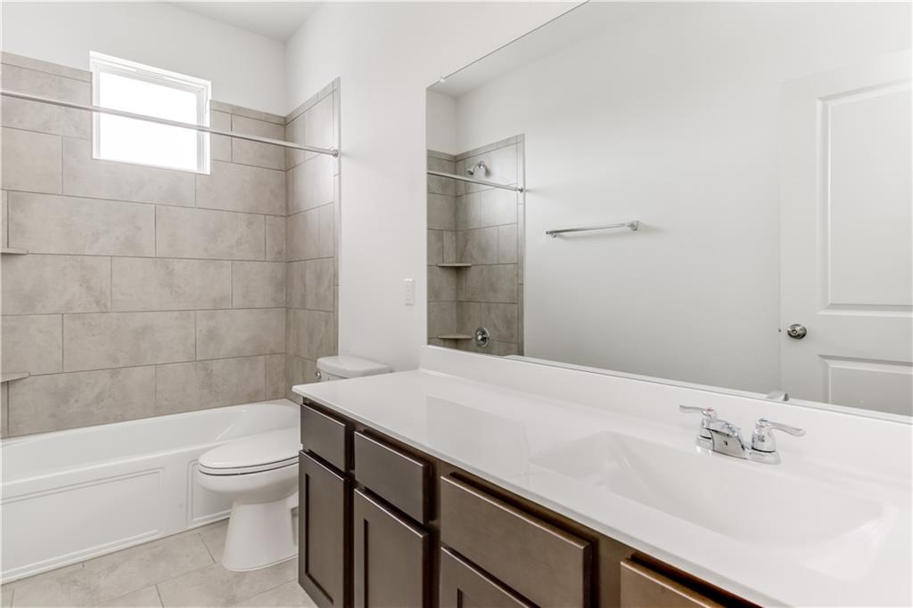 712 Affazia Lane Georgetown, TX 78628 - Photo 27 of 40 a bathroom with a sink a toilet and shower