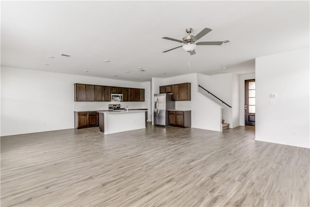 712 Affazia Lane Georgetown, TX 78628 - Photo 6 of 40 a view of empty room with wooden floor and ceiling fan