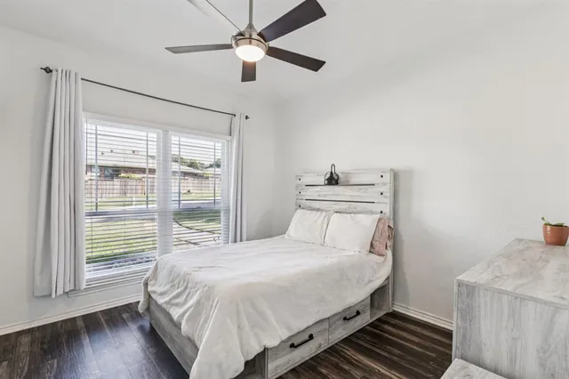 a bedroom with a large bed and a window