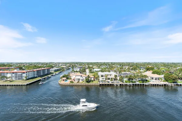 a view of a lake with boats and trees in the background