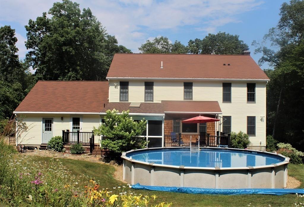 50 Ragged Hill Road West Brookfield, MA 01585 - Photo 3 of 31 a front view of a house with swimming pool and porch