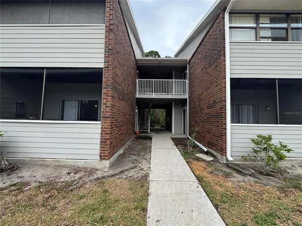 a view of a house with more windows and brick walls