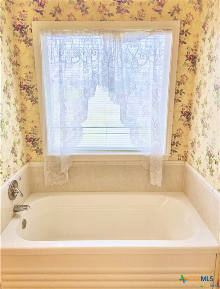 415 South Trinity Street Edna, TX 77957 - Photo 27 of 46 a bathroom with a bathtub and shower