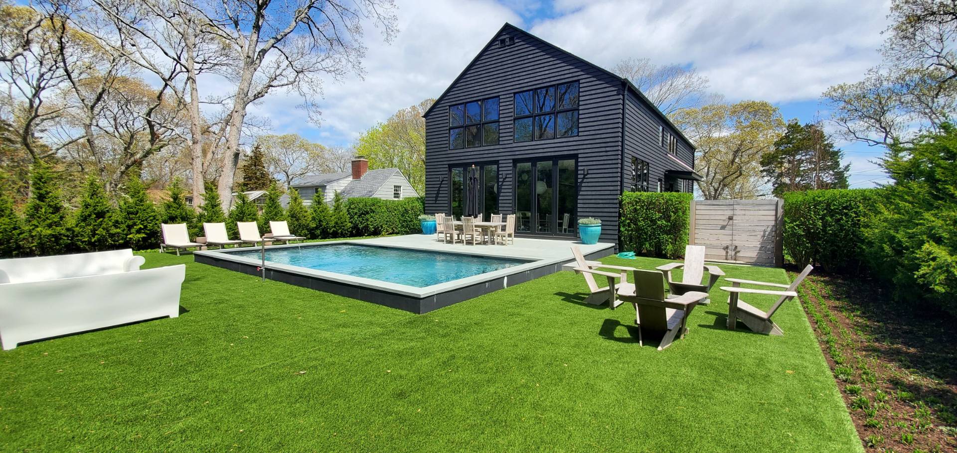 a view of a house with backyard and sitting area