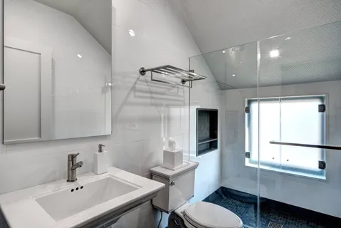 a bathroom with a sink toilet tub and shower