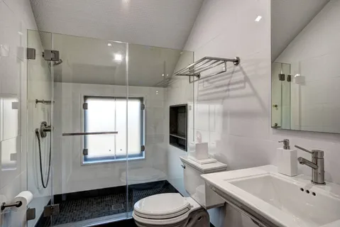 a bathroom with a sink a mirror and a shower