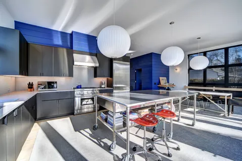 a kitchen with stainless steel appliances a stove a sink dishwasher and cabinets with wooden floor