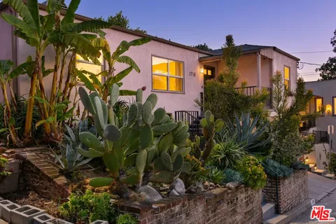 a view of a house with a flower garden