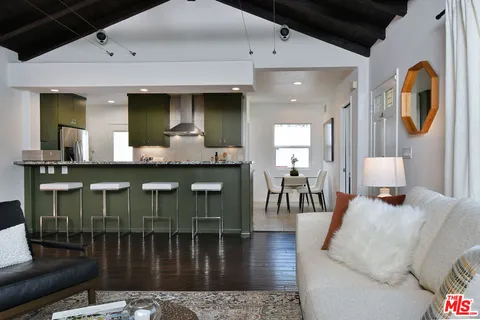 a kitchen with a table chairs and a refrigerator