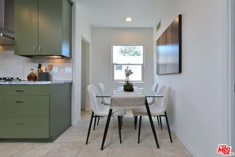 a bedroom with a bed and painting on the wall
