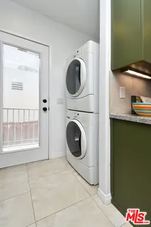a view of a hallway with a livingroom and a bathroom with sink
