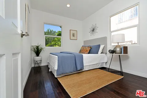 a bedroom with bed and a window