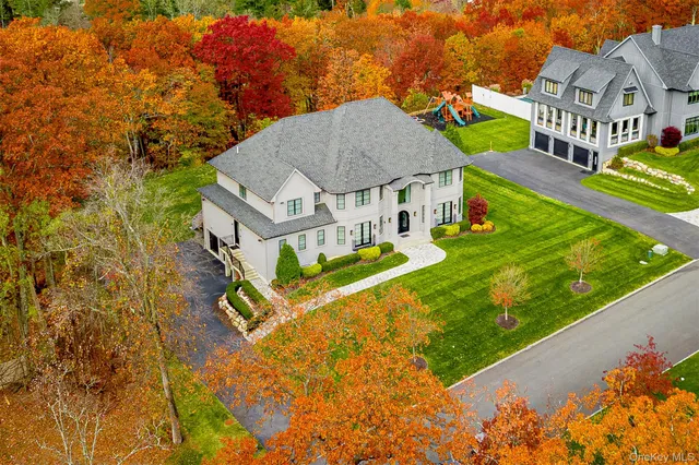 an aerial view of residential houses with yard