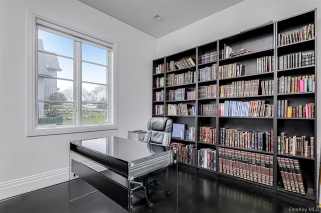 a living room with furniture and a book shelf