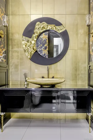 a closeup of a sink with granite countertop a stove