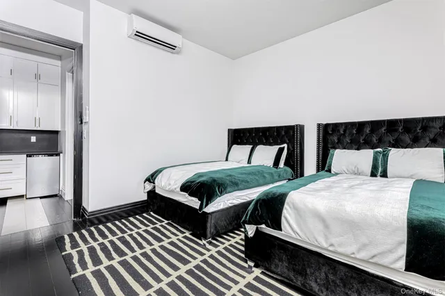 a bedroom with two beds and painting on the wall