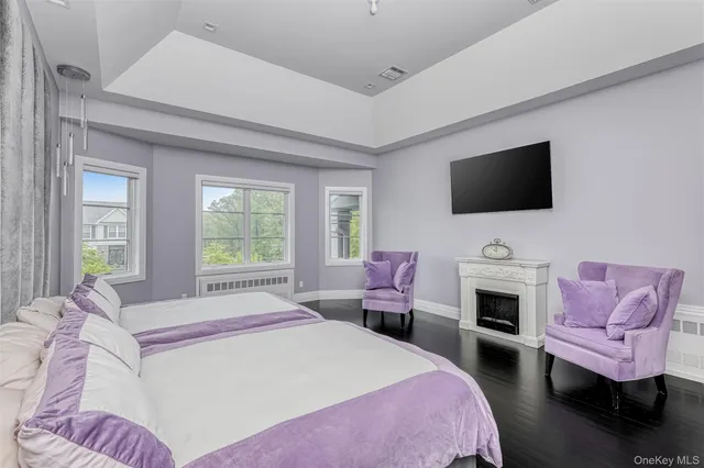 a spacious bedroom with a bed and a flat screen tv