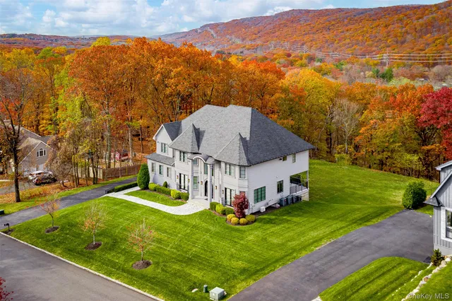 an aerial view of a house with a big yard