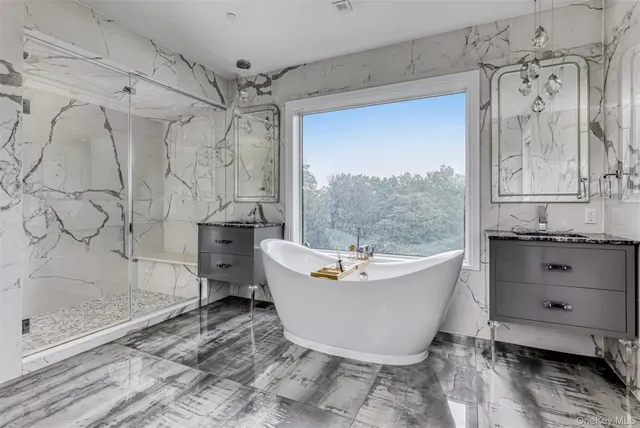 a bathroom with a bathtub and shower