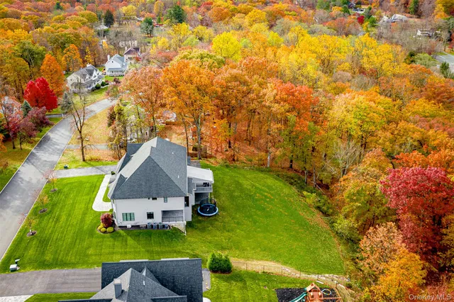 a view of a house with a big yard and swimming pool