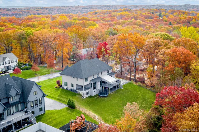 an aerial view of a house with a garden and swimming pool