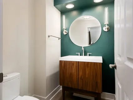 a bathroom with a sink mirror and toilet