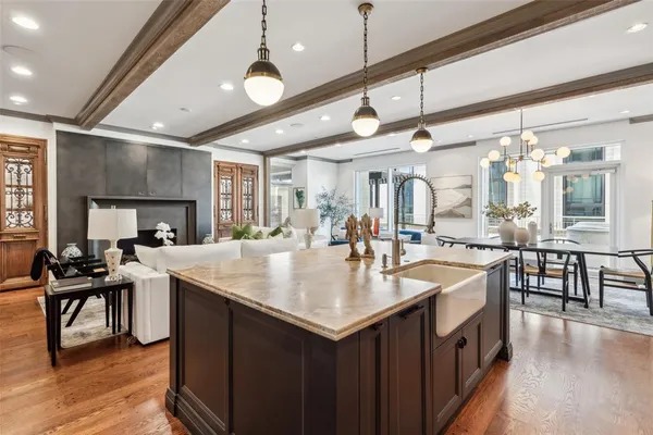 a large kitchen with a counter space a sink appliances and a large window