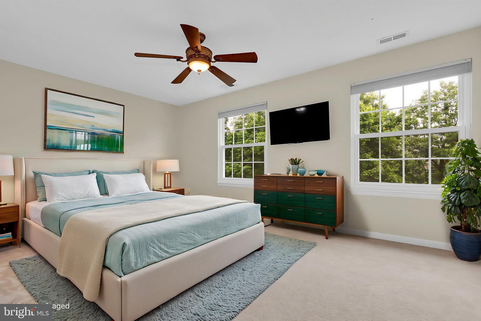 7150 Natures Road Columbia, MD 21046 - Photo 15 of 45 a spacious bedroom with a bed and a flat screen tv