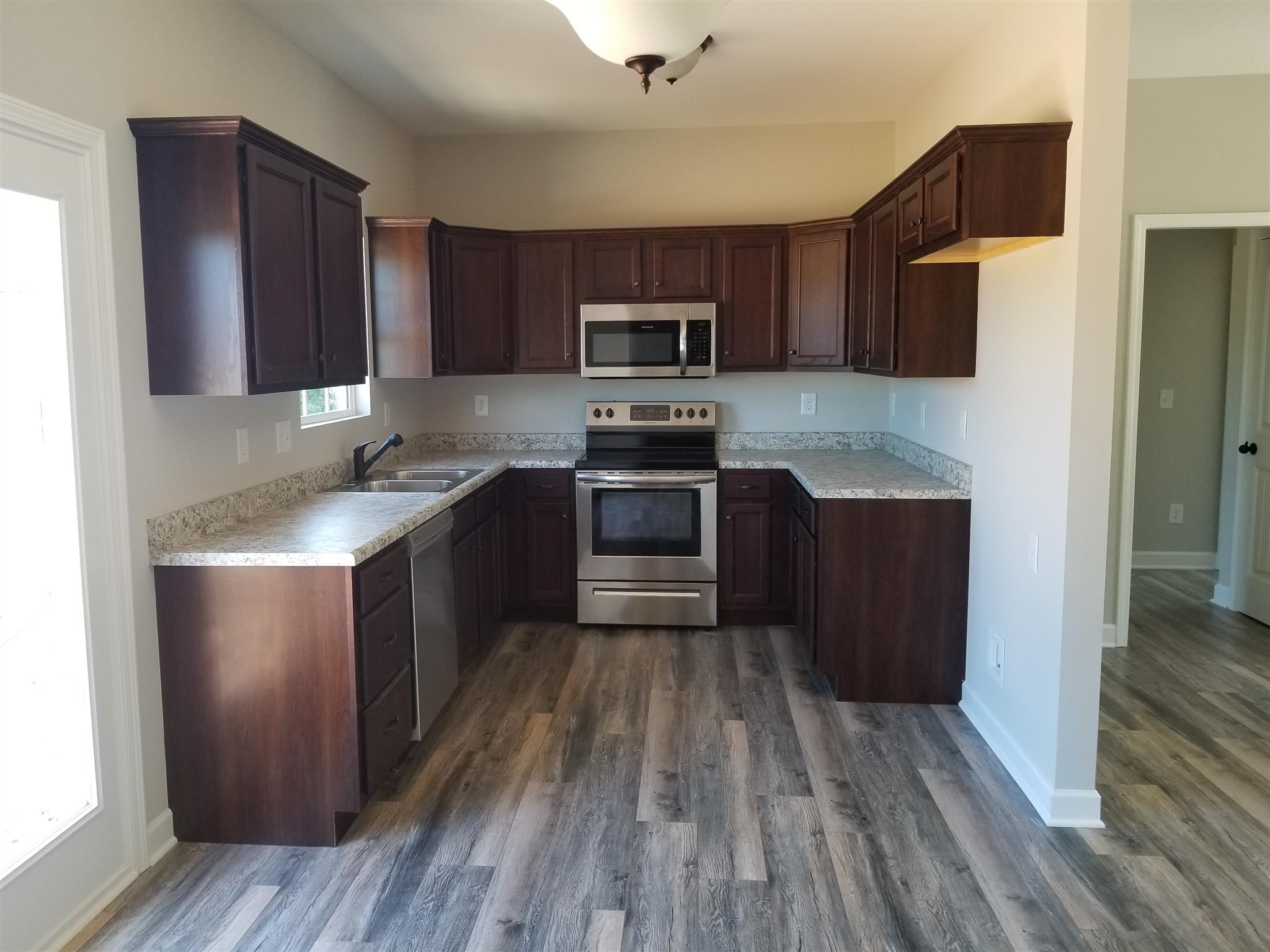 2290 Eugene Reed Road Woodbury, TN 37190 - Photo 4 of 12 Kitchen with stainless steel appliances and hardwood