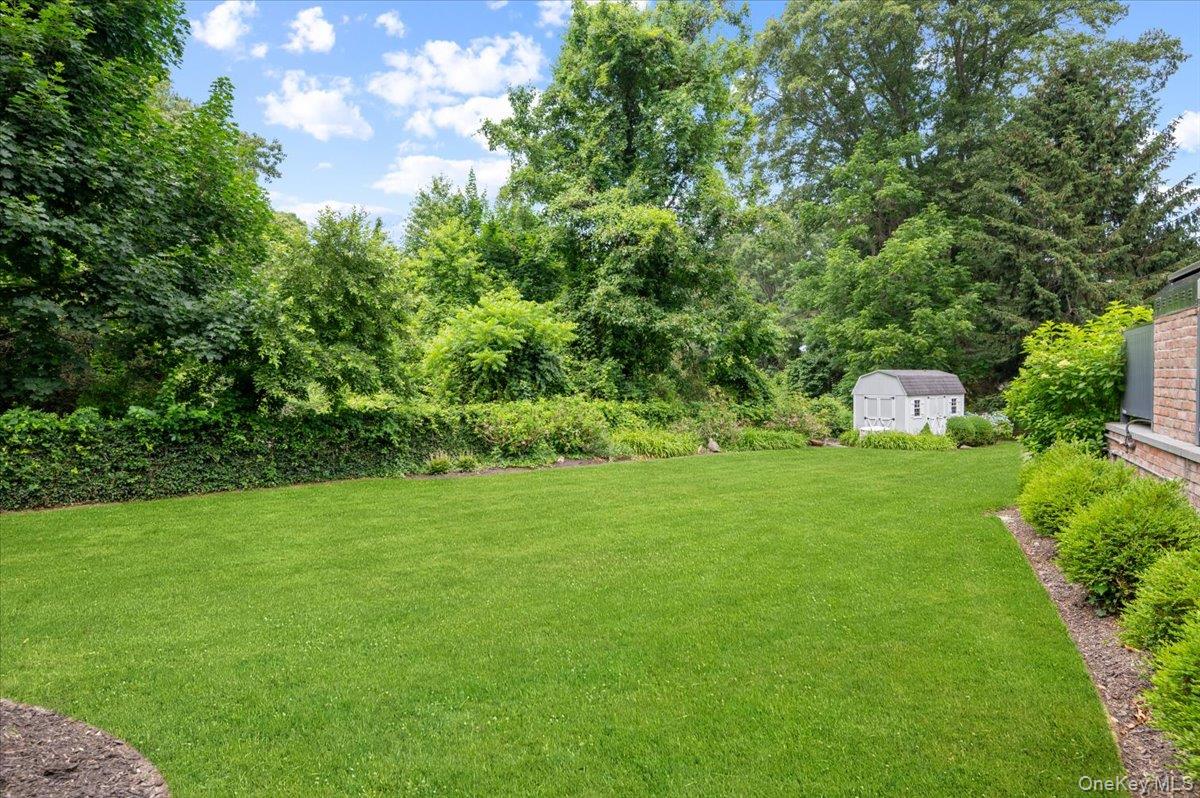 5 Fox Hunt Court Cold Spring Harbor, NY 11724 - Photo 32 of 42 Expansive lawn area featuring a white storage shed