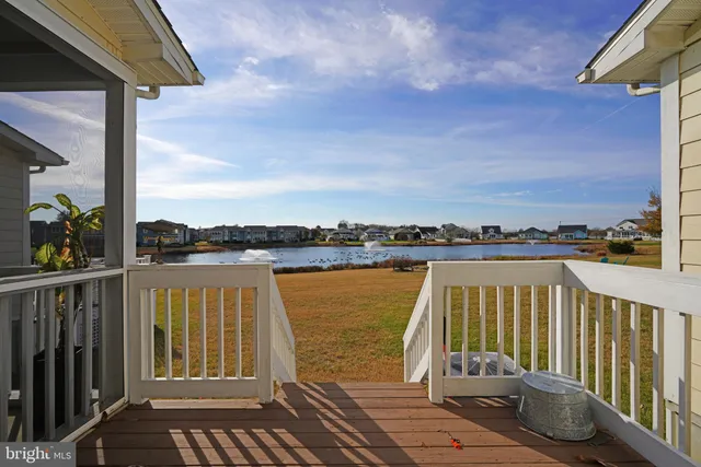 a view of a balcony with wooden floor and fence