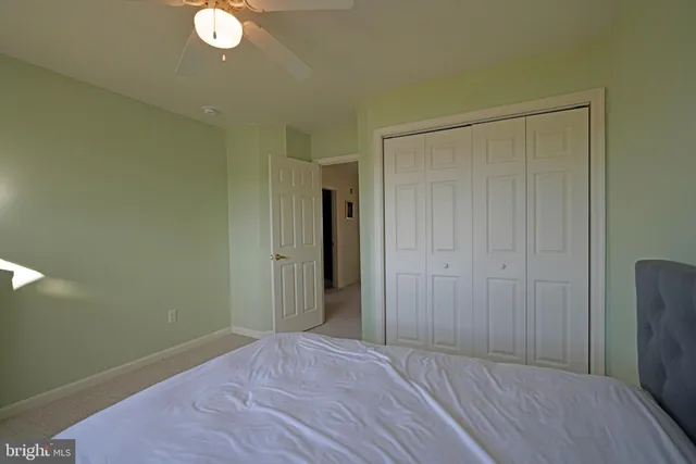 a bedroom with a bed and a closet