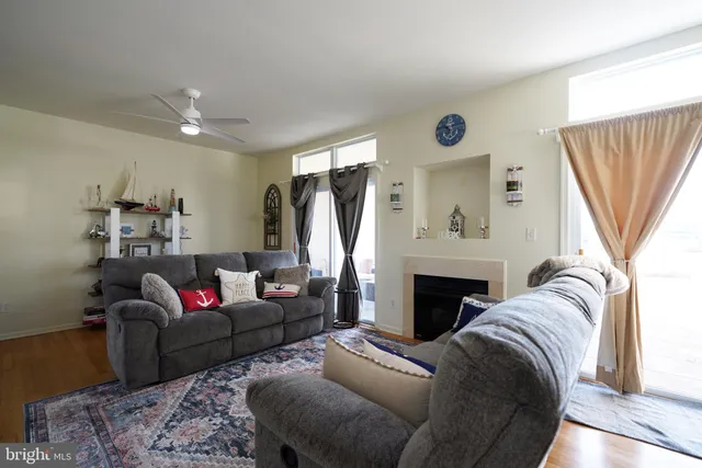 a living room with furniture a window and a fireplace
