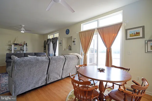 a living room with furniture a window and a table