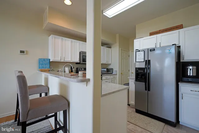 a kitchen with stainless steel appliances a refrigerator and a refrigerator