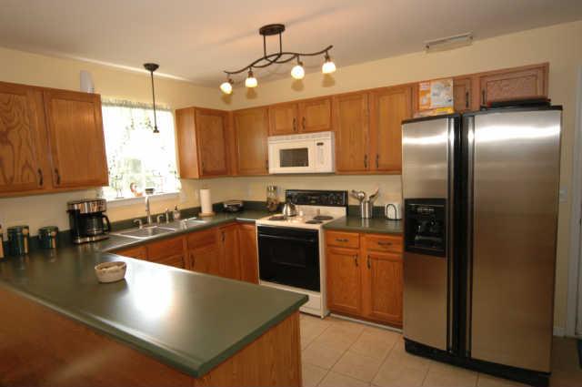 1428 Weston Lane Spring Hill, TN 37174 - Photo 10 of 19 a kitchen with stainless steel appliances granite countertop a sink a stove and a refrigerator
