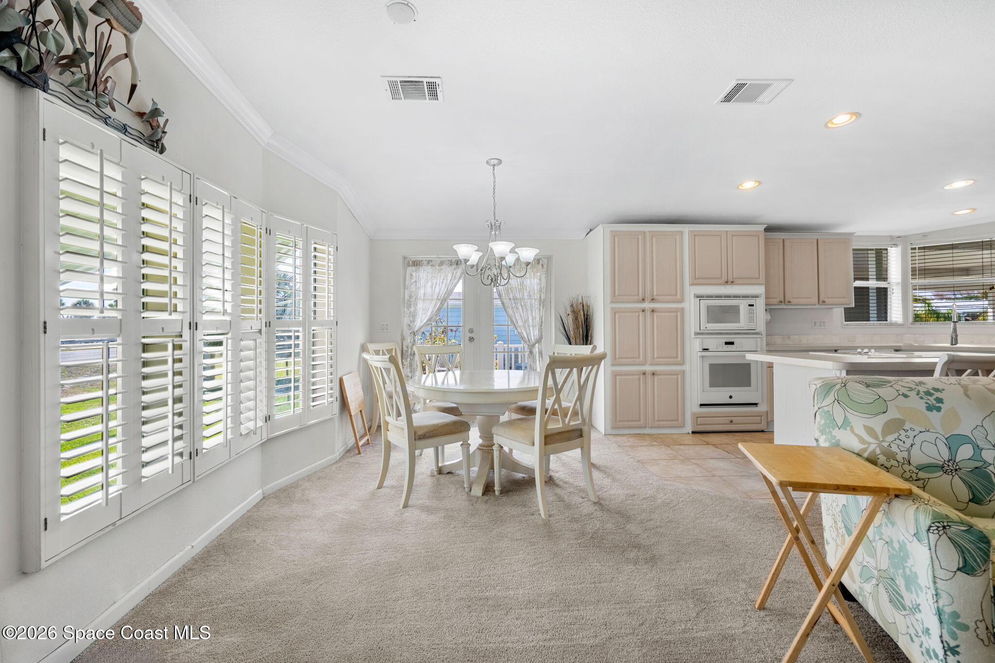 7505 Agawam Road Micco, FL 32976 - Photo 25 of 47 a view of a dining room with furniture and chandelier