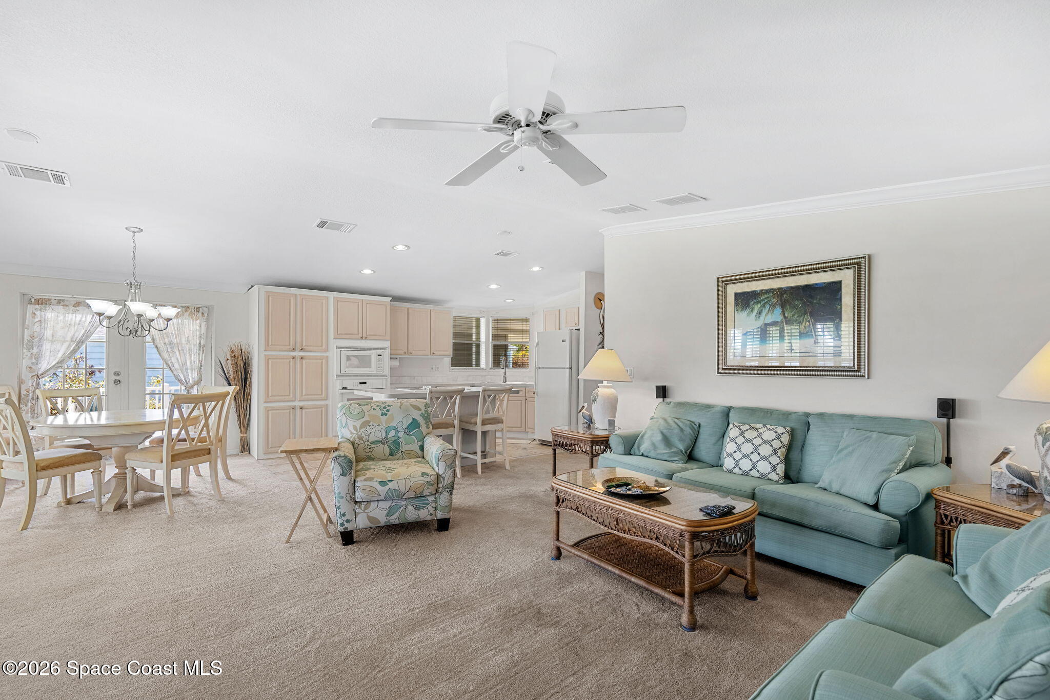 7505 Agawam Road Micco, FL 32976 - Photo 30 of 47 a living room with furniture and a chandelier