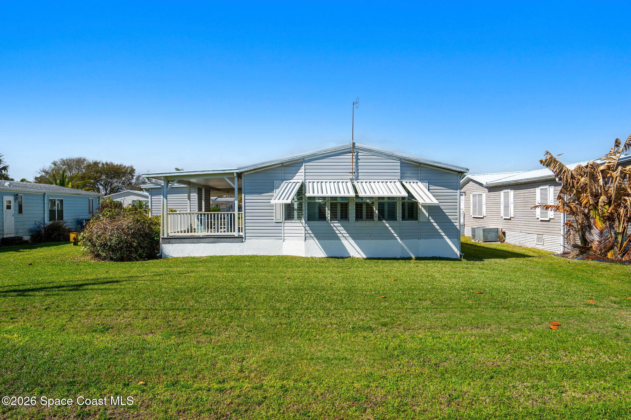 7505 Agawam Road Micco, FL 32976 - Photo 3 of 47 a front view of a house with a garden