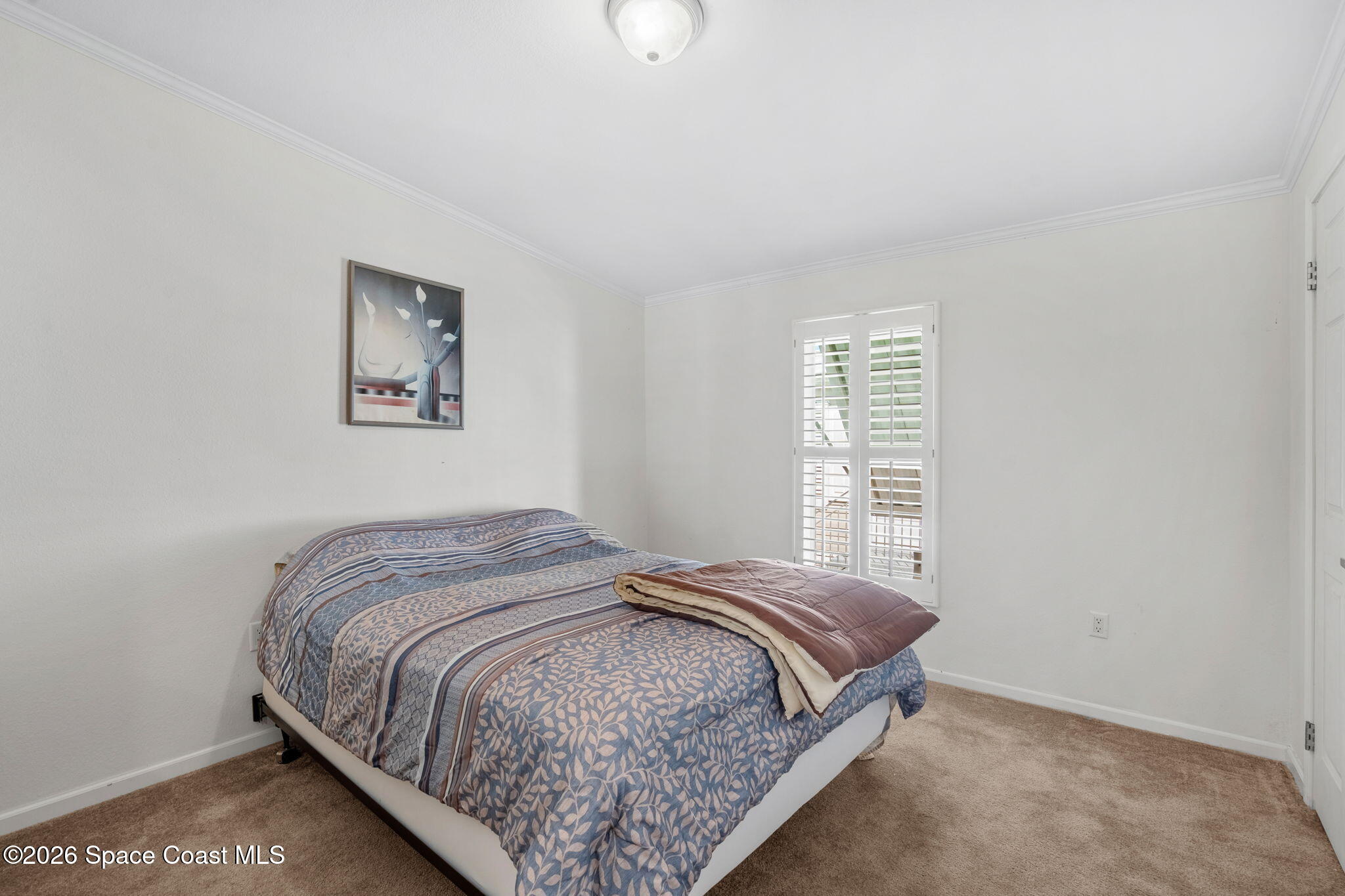 7505 Agawam Road Micco, FL 32976 - Photo 34 of 47 a bedroom with a bed and a window