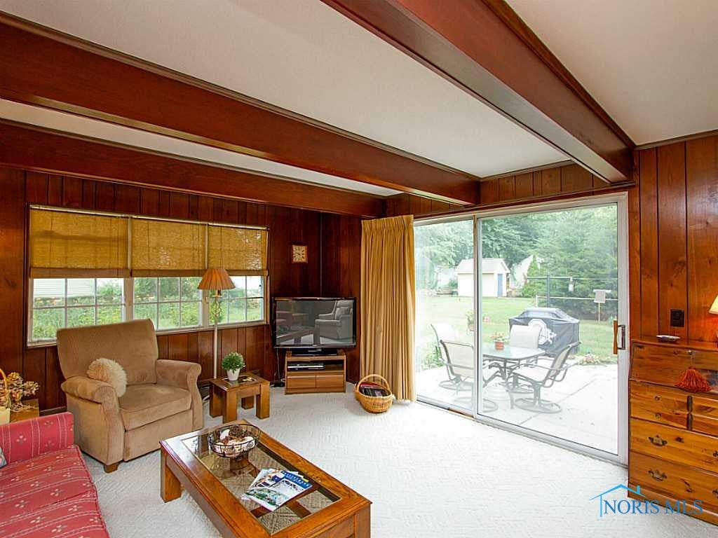 3835 Elmhurst Road Toledo, OH 43613 - Photo 8 of 20 Family Room. Family room with direct access to the patio. Wood beams and tons of natural light.