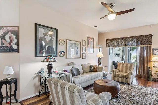 a living room with furniture and kitchen view