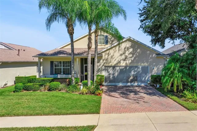 a front view of a house with a garden and yard